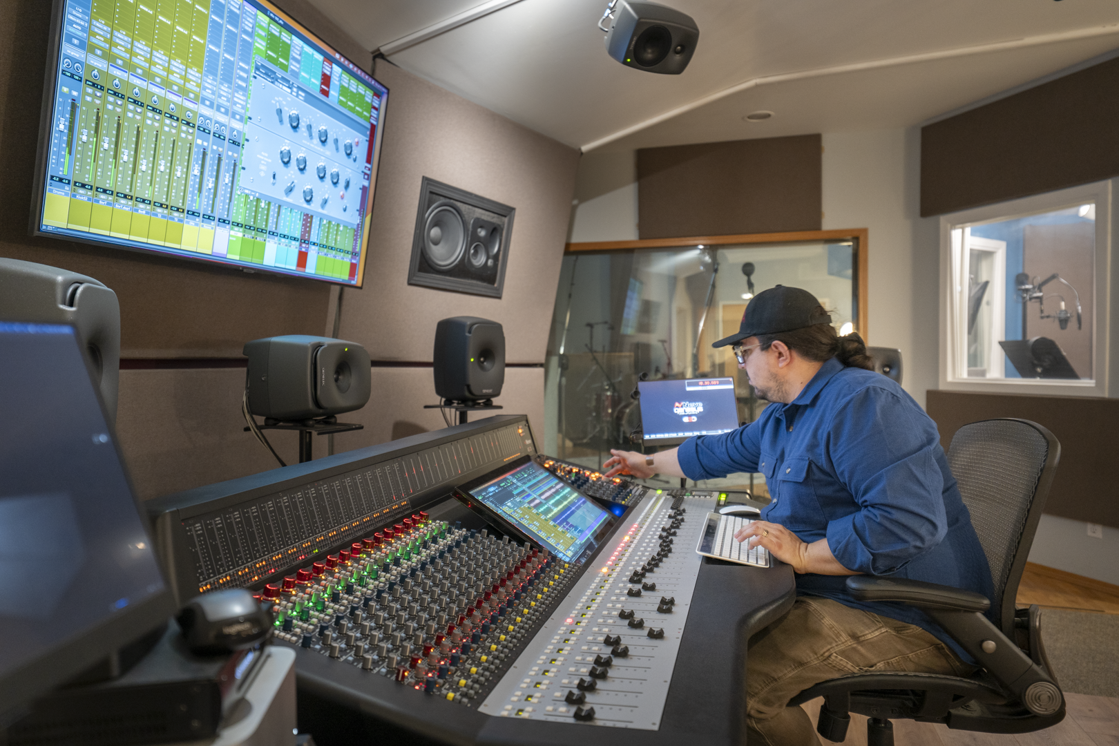 An audio engineer works at the Neve Genesys G3D console at Frostline Studios.
